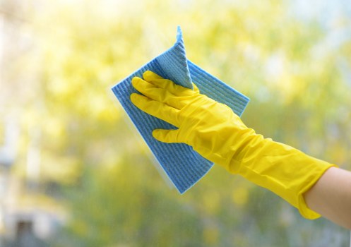 Cleaning technician preparing carpet cleaning equipment safely before work begins